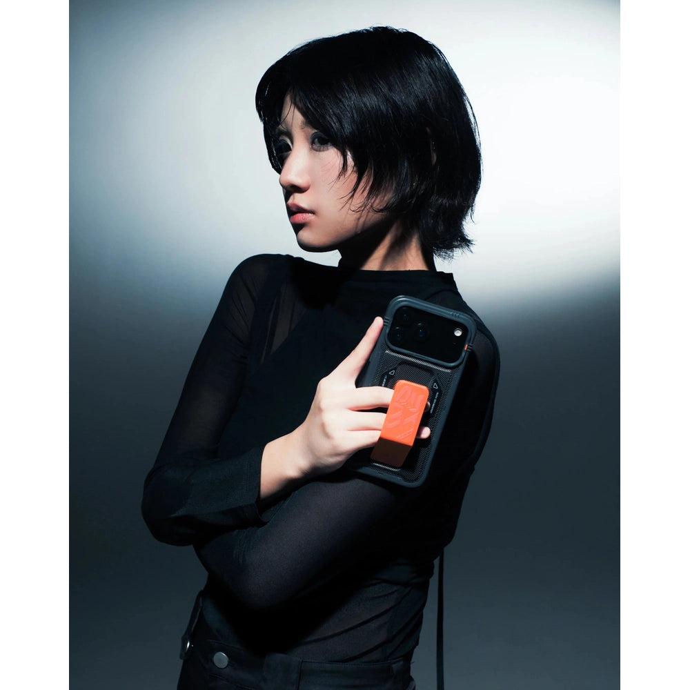 Person demonstrating black Skinarma iPhone 17 Phantom case foldable grip-stand in use
