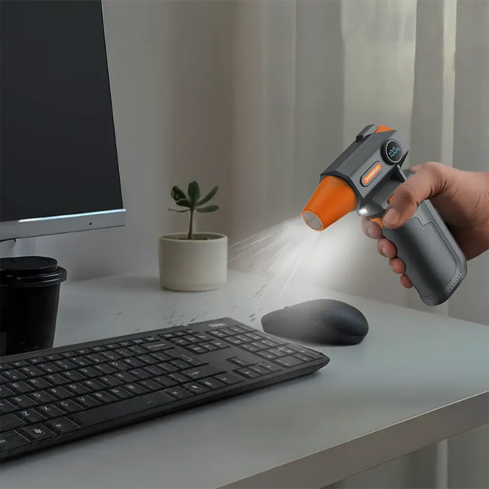 Using Porodo LED air duster to clean computer keyboard
