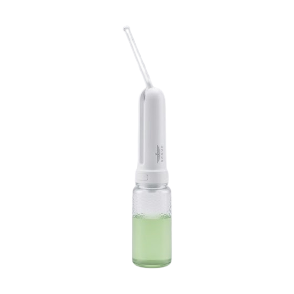 White portable electric bidet with green liquid in transparent tank
