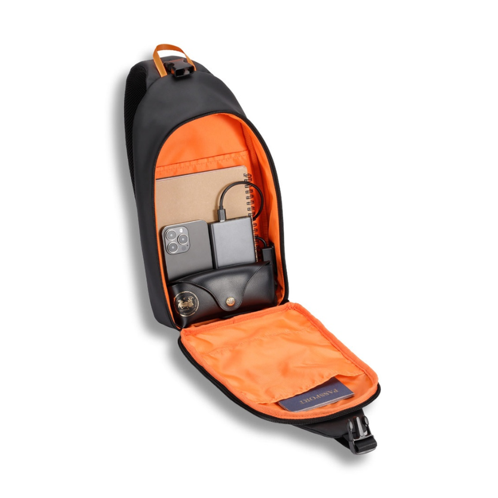 Open black crossbody bag showing orange lining and built-in charging setup